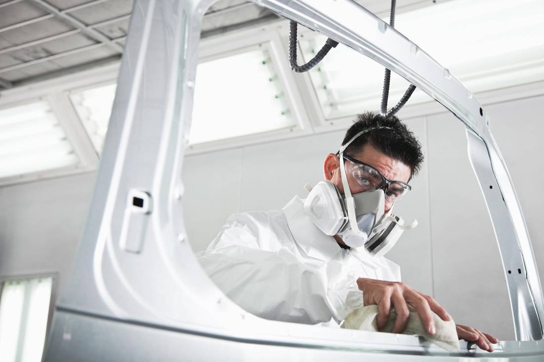 Man, 40s, wearing protective gear for painting auto parts